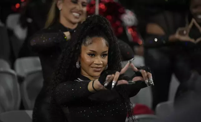 Saweetie performs with a dance group as San Diego State plays Washington State during the second half of an NCAA college football game Saturday, Oct. 26, 2024, in San Diego. (AP Photo/Gregory Bull)