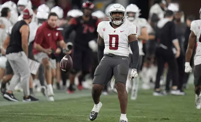 Washington State linebacker Taariq Al-Uqdah (0) celebrates an interception during the second half of an NCAA college football game against San Diego State Saturday, Oct. 26, 2024, in San Diego. (AP Photo/Gregory Bull)