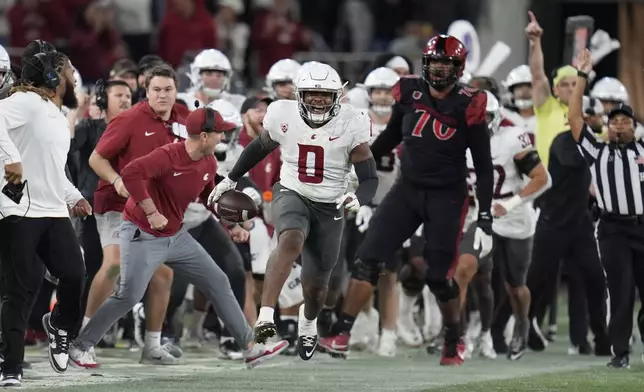 Washington State linebacker Taariq Al-Uqdah (0) celebrates an interception during the second half of an NCAA college football game against San Diego State Saturday, Oct. 26, 2024, in San Diego. (AP Photo/Gregory Bull)