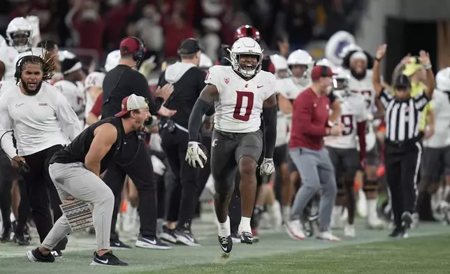 Washington State linebacker Taariq Al-Uqdah (0) celebrates an interception during the second half of an NCAA college football game against San Diego State Saturday, Oct. 26, 2024, in San Diego. (AP Photo/Gregory Bull)