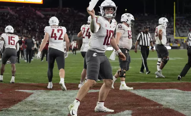 Washington State quarterback John Mateer (10) celebrates a touchdown during the second half of an NCAA college football game against San Diego State Saturday, Oct. 26, 2024, in San Diego. (AP Photo/Gregory Bull)