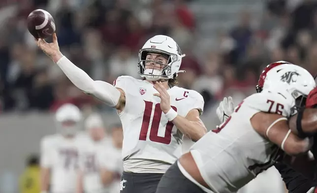 Washington State quarterback John Mateer throws a pass during the first half of an NCAA college football game against San Diego State Saturday, Oct. 26, 2024, in San Diego. (AP Photo/Gregory Bull)