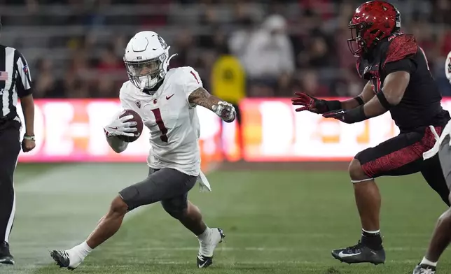 Washington State wide receiver Kris Hutson runs with the ball during the first half of an NCAA college football game against San Diego State Saturday, Oct. 26, 2024, in San Diego. (AP Photo/Gregory Bull)