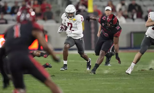 Washington State wide receiver Kyle Williams runs with the ball during the first half of an NCAA college football game against San Diego State Saturday, Oct. 26, 2024, in San Diego. (AP Photo/Gregory Bull)