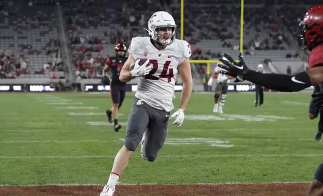 Washington State tight end Cooper Mathers scores a touchdown during the first half of an NCAA college football game against San Diego State Saturday, Oct. 26, 2024, in San Diego. (AP Photo/Gregory Bull)