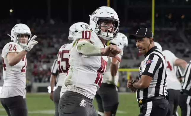 Washington State quarterback John Mateer (10) celebrates a touchdown during the second half of an NCAA college football game against San Diego State Saturday, Oct. 26, 2024, in San Diego. (AP Photo/Gregory Bull)