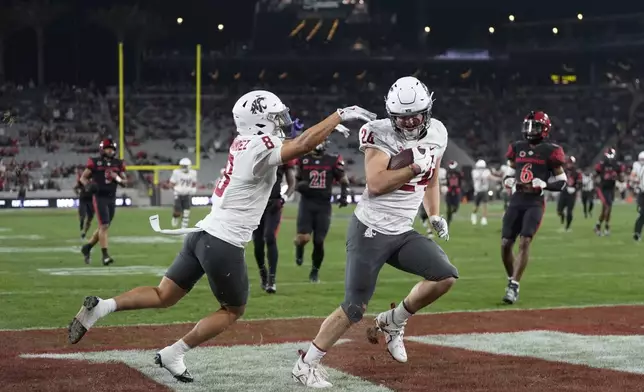 Washington State tight end Cooper Mathers, right, celebrates with teammate wide receiver Carlos Hernandez after scoring a touchdown during the first half of an NCAA college football game against San Diego State Saturday, Oct. 26, 2024, in San Diego. (AP Photo/Gregory Bull)