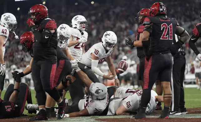 Washington State quarterback John Mateer, center, gets up after scoring a touchdown during the first half of an NCAA college football game against San Diego State Saturday, Oct. 26, 2024, in San Diego. (AP Photo/Gregory Bull)