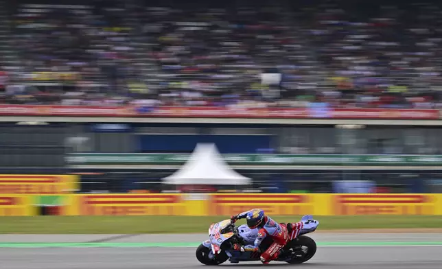 Spain's rider Marc Marquez steers his motorcycle during a practice round of Thailand's MotoGP at the Chang International Circuit in Buriram, Thailand, Saturday, Oct. 26, 2024. (AP Photo/Kittinun Rodsupan)