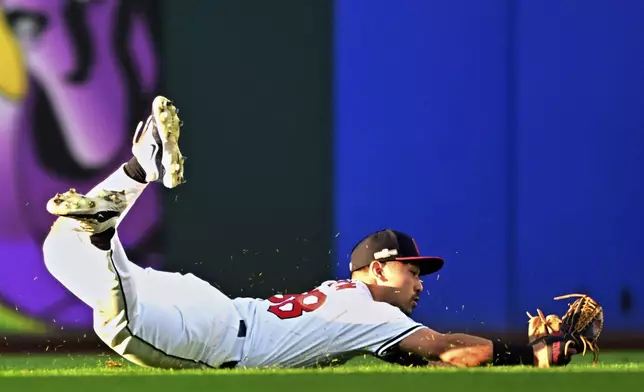 Cleveland Guardians left fielder Steven Kwan makes a diving catch on a fly ball hit by Detroit Tigers' Wenceel Pérez for an out in the eighth inning during Game 2 of baseball's AL Division Series, Monday, Oct. 7, 2024, in Cleveland. (AP Photo/David Dermer)