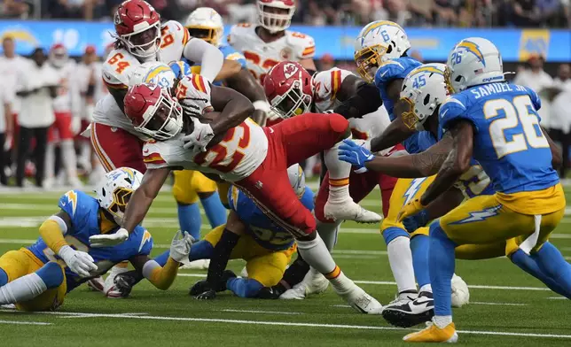 Kansas City Chiefs running back Kareem Hunt (29) struggles for yardage during the second half of an NFL football game against the Los Angeles Chargers Sunday, Sept. 29, 2024, in Inglewood, Calif. (AP Photo/Marcio Jose Sanchez)