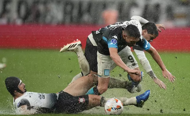 Andre Ramalho of Brazil's Corinthians tackles Juan Nardoni of Argentina's Racing Club during a Copa Sudamericana semifinal first leg soccer match at Neo Quimica arena in Sao Paulo, Thursday, Oct. 24, 2024. (AP Photo/Andre Penner)