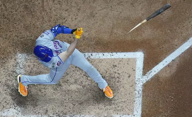 New York Mets' Pete Alonso hits a broken-bat single during the seventh inning of Game 2 of a National League wild card baseball game against the Milwaukee Brewers Wednesday, Oct. 2, 2024, in Milwaukee. (AP Photo/Morry Gash)