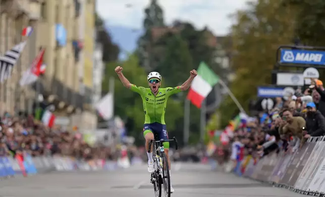 Slovenia's Tadej Pogacar crosses the finish line to win the Men Elite road race of the Cycling and Para-cycling Road World Championships in Zurich, Switzerland, Sunday, Sept. 29, 2024. (AP Photo/Peter Dejong)