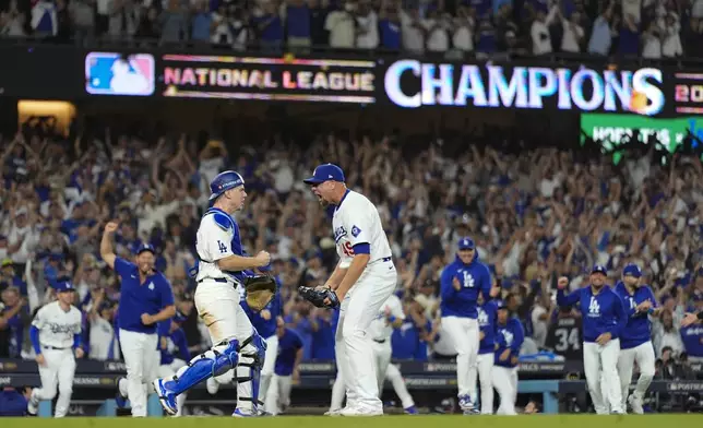 Los Angeles Dodgers pitcher Blake Treinen and catcher Will Smith celebrate their win against the New York Mets in Game 6 of a baseball NL Championship Series, Sunday, Oct. 20, 2024, in Los Angeles. (AP Photo/Julio Cortez)