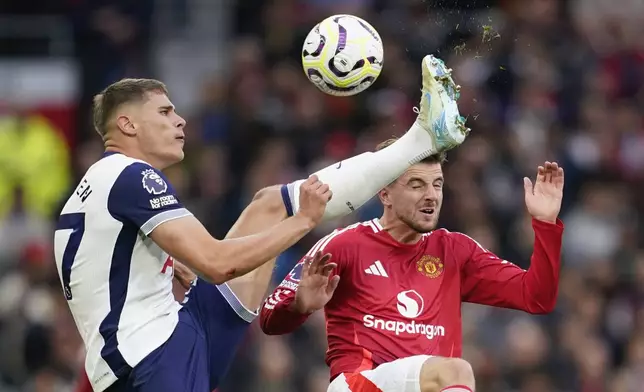 Tottenham's Micky van de Ven, left, challenges for the ball with Manchester United's Mason Mount during the English Premier League soccer match between Manchester United and Tottenham Hotspur at Old Trafford stadium in Manchester, England, Sunday, Sept. 29, 2024. (AP Photo/Dave Thompson)