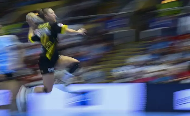 In this image taken with a slow shutter speed, Maja Magnussen of Nykobing Falster tries to score during the Champions League women's handball match between CSM Bucuresti and Denmark's Nykobing Falster, at the Polyvalent Hall in Bucharest, Romania, Sunday, Oct. 6, 2024. (AP Photo/Raed Krishan)