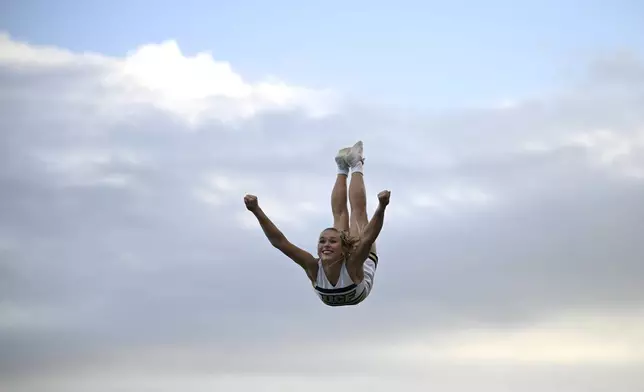 Central Florida cheerleaders perform on the field during the second half of an NCAA college football game against Cincinnati, Saturday, Oct. 12, 2024, in Orlando, Fla. (AP Photo/Phelan M. Ebenhack)