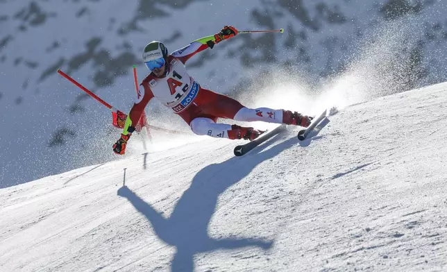 Austria's Manuel Feller speeds down the course during an alpine ski, men's World Cup giant slalom, in Soelden, Austria, Sunday, Oct. 27, 2024. (AP Photo/Alessandro Trovati)