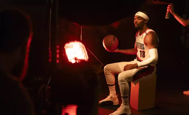 Portland Trail Blazers guard Devonte' Graham poses for a photo as spray fog is used behind him during the NBA basketball team's media day in Portland, Ore., Monday, Sept. 30, 2024. (AP Photo/Jenny Kane)