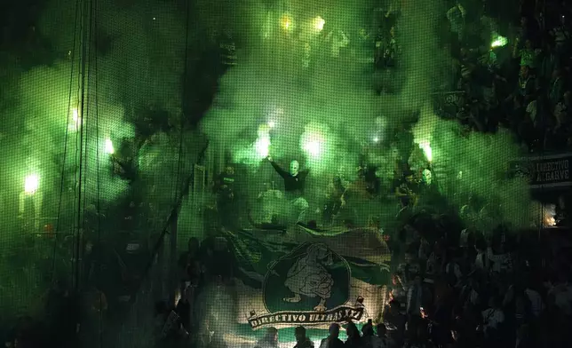 Soccer fans let off flares ahead of the Champions League opening phase soccer match between PSV Eindhoven and Sporting CP at Philips stadium in Eindhoven, Netherlands, Tuesday, Oct. 1, 2024. (AP Photo/Peter Dejong)