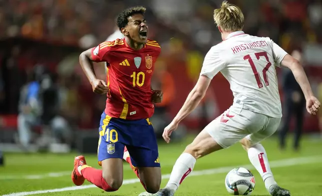 Spain's Lamine Yamal, left, and Denmark's Victor Kristiansen battle for the ball during the UEFA Nations League group 4 soccer match between Spain and Denmark in Murcia, Spain, Saturday, Oct. 12, 2024. (AP Photo/Jose Breton)