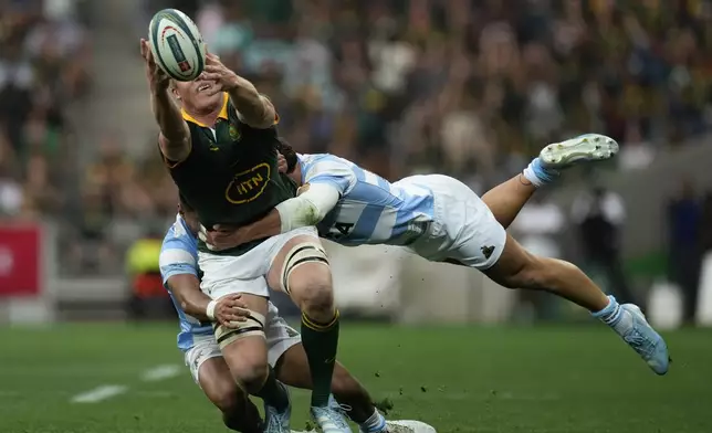 South Africa's Pieter-Steph du Toit, left, is tackled by Argentina's Rodrigo Isgro during a rugby championship test match at Mbombela stadium in Nelspruit, South Africa, Saturday, Sept. 28, 2024. (AP Photo/Themba Hadebe)