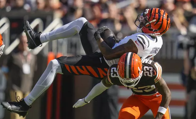 Cincinnati Bengals wide receiver Tee Higgins (5) pulls in a pass reception over Cleveland Browns cornerback Martin Emerson Jr. (23) in the first half of an NFL football game, Sunday, Oct. 20, 2024, in Cleveland. (AP Photo/Sue Ogrocki)