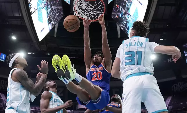 New York Knicks guard Jericho Sims dunks against the Charlotte Hornets during the second half of a preseason NBA basketball game on Sunday, Oct. 6, 2024, in Charlotte, N.C. (AP Photo/Chris Carlson)