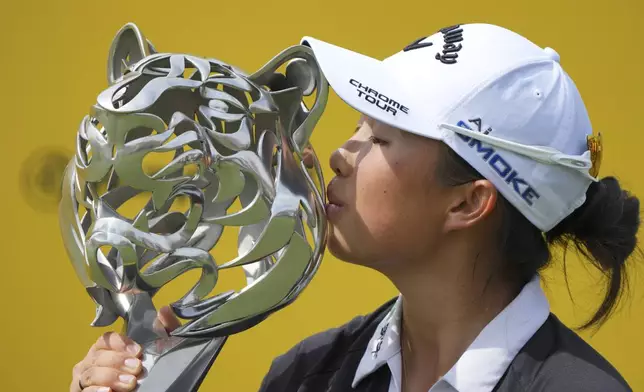 Yin Ruoning of China kisses the trophy during the awards ceremony after winning the LPGA Tour's Maybank Championship at Kuala Lumpur Golf and Country club in Kuala Lumpur, Sunday, Oct. 27, 2024. (AP Photo/Vincent Thian)