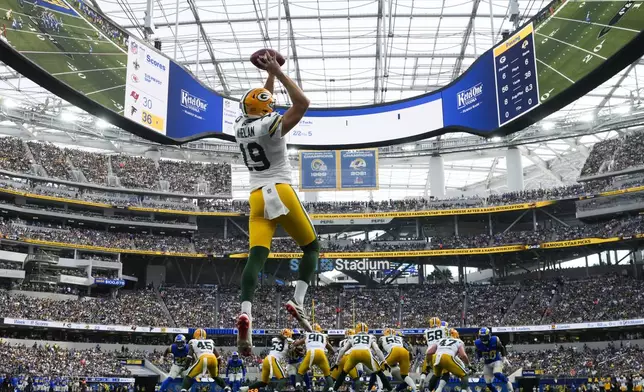 Green Bay Packers punter Daniel Whelan (19) grabs a high snap during the first half of an NFL football game against the Los Angeles Rams, Sunday, Oct. 6, 2024, in Inglewood, Calif. (AP Photo/Gregory Bull)