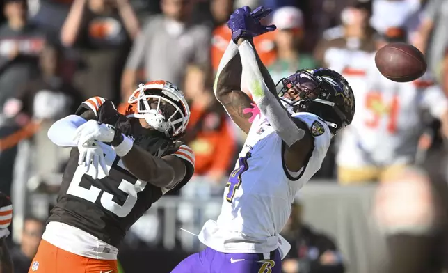 Baltimore Ravens wide receiver Zay Flowers (4) drops a pass in the end zone with Cleveland Browns cornerback Martin Emerson Jr. (23) in the finals second of the second half of an NFL football game in Cleveland, Sunday, Oct. 27, 2024. (AP Photo/David Richard)