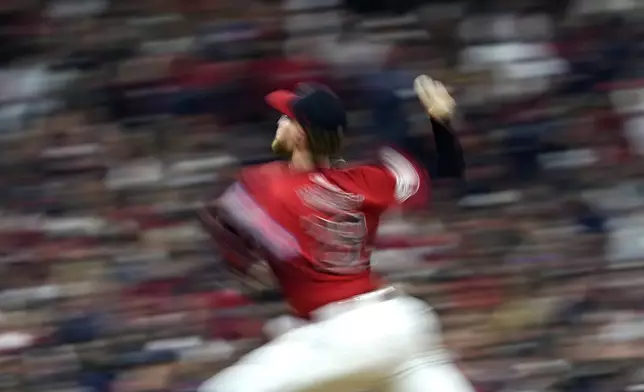 In this image taken with a slow shutter speed, Cleveland Guardians starting pitcher Tanner Bibee throws against the New York Yankees during the fourth inning in Game 5 of the baseball AL Championship Series Saturday, Oct. 19, 2024, in Cleveland. (AP Photo/Godofredo A. Vásquez)