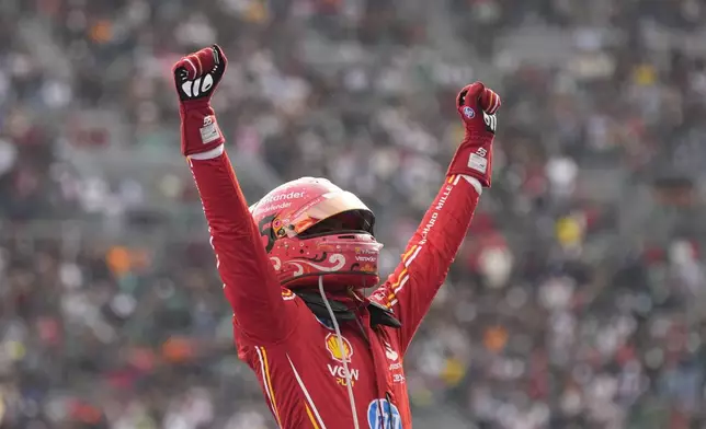 Ferrari driver Carlos Sainz of Spain celebrates after winning the Formula One Mexico Grand Prix auto race at the Hermanos Rodriguez racetrack in Mexico City, Sunday, Oct. 27, 2024. (AP Photo/Moises Castillo)