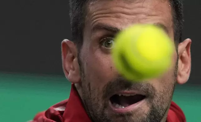 Novak Djokovic of Serbia eyes on the ball during the men's singles semifinals match against Taylor Fritz of the United States in the Shanghai Masters tennis tournament at Qizhong Forest Sports City Tennis Center in Shanghai, China, Saturday, Oct. 12, 2024. (AP Photo/Andy Wong)