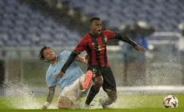 Lazio's Luca Pellegrini, left, and Nice's Youssoufa Moukoko fight for the ball during an Europa League opening phase soccer match between Lazio and Nice, at Rome's Olympic Stadium, Thursday, Oct. 3, 2024. (AP Photo/Andrew Medichini)