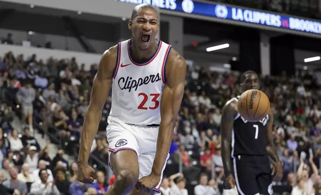 Los Angeles Clippers forward Kai Jones reacts after dunking the ball during the second half of a preseason NBA basketball game against the Brooklyn Nets, Tuesday, Oct. 8, 2024, in Oceanside, Calif. (AP Photo/Ryan Sun)