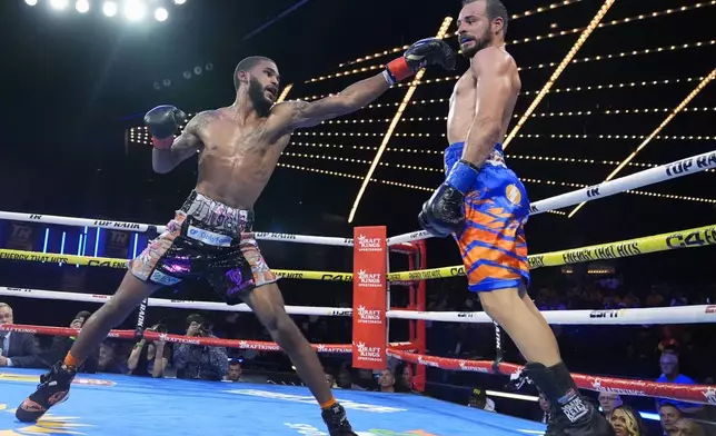 Delante Johnson, left, punches Puerto Rico's Yomar Alamo, right, during their welterweight boxing bout Friday, Sept. 27, 2024, in New York. Johnson won the fight. (AP Photo/Frank Franklin II)