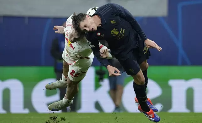 Leipzig's David Raum, left, and Juventus' Nicolo Savona go for the ball during the UEFA Champions League opening phase soccer match between Leipzig and Juventus in Leipzig, Germany, Wednesday, Oct. 2, 2024.(AP Photo/Ebrahim Noroozi)