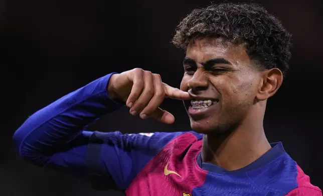 Barcelona's Lamine Yamal celebrates after scoring his side's third goal during the Spanish La Liga soccer match between Real Madrid and Barcelona at the Santiago Bernabeu stadium in Madrid, Spain, Saturday, Oct. 26, 2024. (AP Photo/Manu Fernandez)