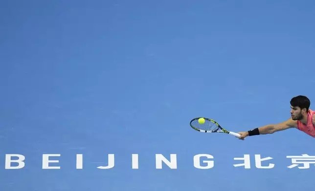 Carlos Alcaraz of Spain returns a shot from Jannik Sinner of Italy during their men's singles finals match of the China Open tennis tournament, at the National Tennis Center in Beijing, Wednesday, Oct. 2, 2024. (AP Photo/Andy Wong)