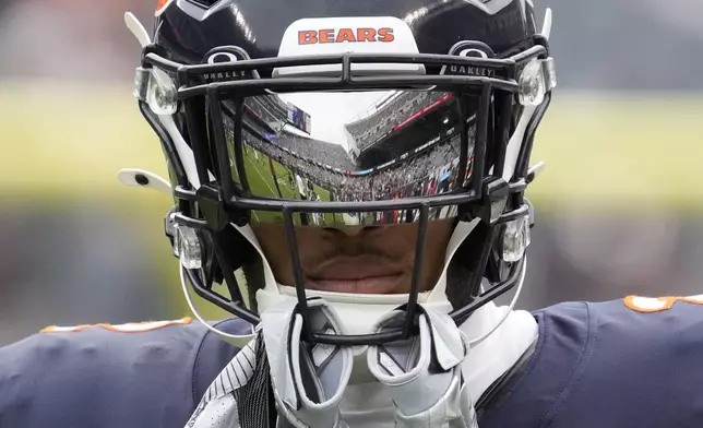 Soldier Field is reflected in the visor of Chicago Bears wide receiver DJ Moore before an NFL football game against the Los Angeles Rams on Sunday, Sept. 29, 2024, in Chicago. (AP Photo/Nam Y. Huh)