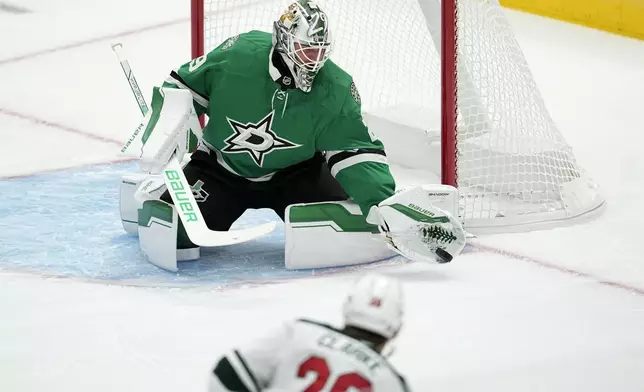 Dallas Stars goaltender Jake Oettinger (29) gloves a shot from the Minnesota Wild in the first period of a preseason NHL hockey game Wednesday, Sept. 25, 2024, in Dallas. (AP Photo/Tony Gutierrez)