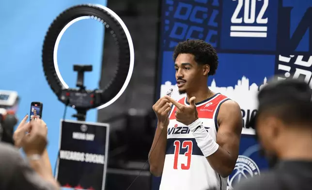 Washington Wizards guard Jordan Poole does a social media spot during the NBA basketball team's media day, Monday, Sept. 30, 2024, in Washington. (AP Photo/Nick Wass)