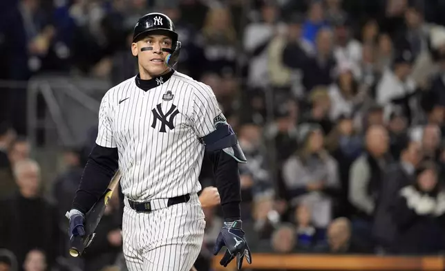 New York Yankees' Aaron Judge walks back to the dugout after striking out against the Los Angeles Dodgers during the first inning in Game 3 of the baseball World Series, Monday, Oct. 28, 2024, in New York. (AP Photo/Godofredo A. Vásquez)