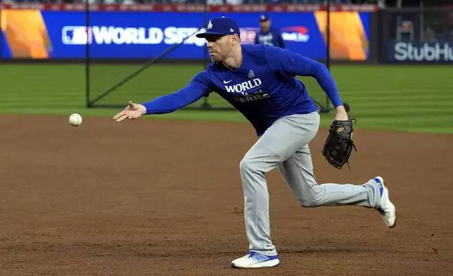 Los Angeles Dodgers first baseman Freddie Freeman tosses the ball during batting practic before Game 5 of the baseball World Series against the New York Yankees, Wednesday, Oct. 30, 2024, in New York. (AP Photo/Godofredo A. Vásquez)