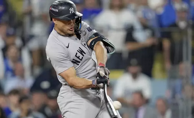 New York Yankees' Giancarlo Stanton hits a RBI single against the Los Angeles Dodgers during the ninth inning in Game 2 of the baseball World Series, Saturday, Oct. 26, 2024, in Los Angeles. (AP Photo/Godofredo A. Vásquez)