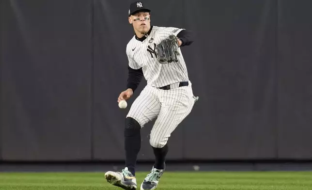 New York Yankees center fielder Aaron Judge makes error fielding on a ball hit by Los Angeles Dodgers' Tommy Edman during the fifth inning in Game 5 of the baseball World Series, Wednesday, Oct. 30, 2024, in New York. (AP Photo/Ashley Landis)