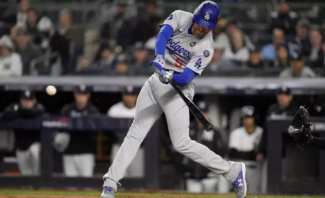 Los Angeles Dodgers' Freddie Freeman hits a two-run home run against the New York Yankees during the first inning in Game 4 of the baseball World Series, Tuesday, Oct. 29, 2024, in New York. (AP Photo/Ashley Landis)