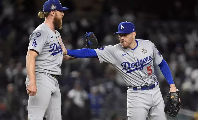 Los Angeles Dodgers' Freddie Freeman (5) and Michael Kopech celebrate after Game 3 of the baseball World Series against the New York Yankees, Monday, Oct. 28, 2024, in New York. The Dodgers won 4-2. (AP Photo/Godofredo A. Vásquez)